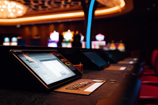 A man celebrating a winning moment on his laptop while gaming symbols float around him, capturing the excitement of 866JL games.