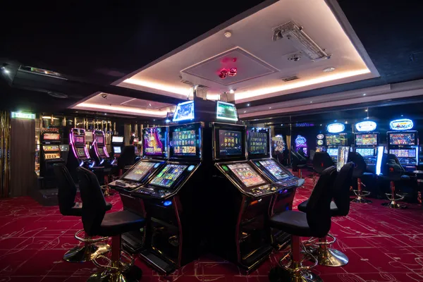 A woman in a luxurious green gown next to an ornate roulette wheel, capturing the upscale casino mood of 866JL.